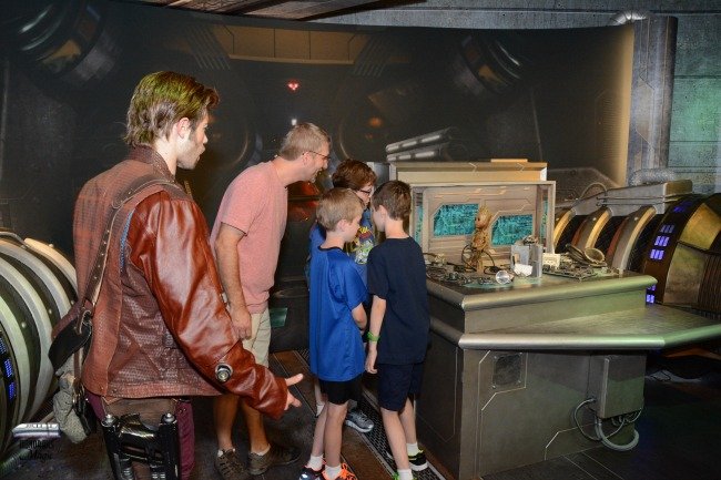 5 Reasons You Need to Use Disney's PhotoPass Service. Candid moment of a family meeting Baby Groot.